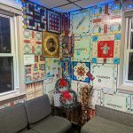 Wall covered in colorful Monopoly game-themed artwork and decor.
