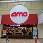 AMC movie theater entrance with large red and white logo above the lobby.