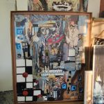 Collection of framed and unframed artwork, including a large, colorful abstract painting.