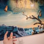 Fantasy painting of ethereal figures above a dramatic ocean wave and driftwood.