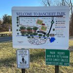 Welcome to Banchoff Park map and park hours sign on a sunny day.