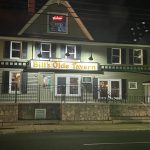 Night view of Bill's Olde Tavern, a historic-looking establishment with illuminated signage.