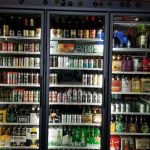 Well-stocked, multi-section liquor cabinet displaying various spirits and bottles.