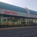 Fast food restaurant with large windows and a turquoise roof, displaying "Good Mood Restaurant."