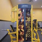 Yellow and black multi-station gym equipment with "Life Fitness" branding in a fitness center.