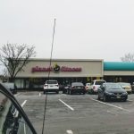 Planet Fitness building with a parking lot under an overcast sky.