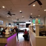 Interior view of a modern fast-food restaurant with counter service and dining area.