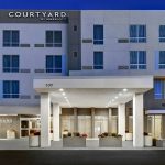 Courtyard by Marriott hotel exterior with modern facade and covered entrance.
