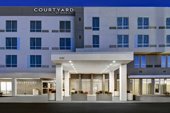 Courtyard by Marriott hotel exterior with modern facade and covered entrance.
