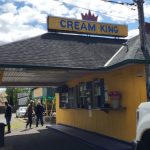 Cream King ice cream shop with a yellow facade under a blue sky.
