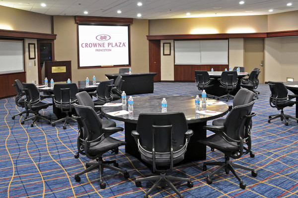 Conference room setup at Crowne Plaza Princeton with tables and chairs.