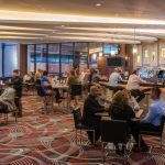 Lively hotel lounge with bar, seating area, and modern decor.