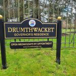 Entrance sign for Drumthwacket, the Governor's Residence, with opening hours listed.