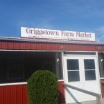 Griggstown Farm Market sign above a red building with white trim and porch.