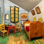 Rustic bedroom interior with wooden bed, colorful walls, and vintage decor.