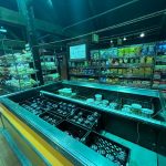 Display case filled with various snacks and sweets in a dimly lit store.