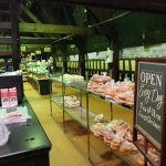 Bakery display case filled with fresh bread, pastries, and baked goods inside a shop.