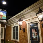Nighttime view of a brick building with "Halo Pub" sign and ornate exterior lighting.