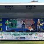 Stage setup for the 36th Annual Irish Festival, featuring musicians and branding.