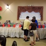 People gather in a decorated room, possibly for an event or celebration.