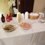 Table display with candy, sprinkles, and various food items for a party or event.