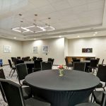 Conference room setup with a large round table and chairs for meetings.