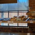 Bakery display case showing various loaves of bread behind a large window.