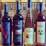Four bottles of Hopewell Valley wine displayed in a cellar setting.