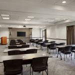Conference room setup with tables and chairs for meetings or presentations.