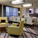 Modern hotel lobby seating area with contemporary furniture and large windows.