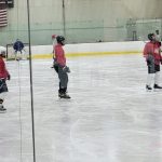 Ice hockey players on the rink during a game or practice session.