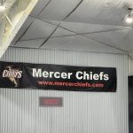 Mercer Chiefs banner displayed on a corrugated metal wall inside a venue.