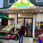 Storefront of Karla's Mini Market with green awning and signage.