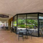 Outdoor patio seating area next to Lillipies Bakery with large glass windows.