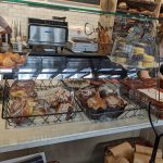 Bakery display case filled with pastries, breads, and baked goods.