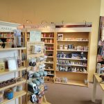 Candle shop interior displaying Yankee Candle products on wooden shelves.