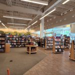 Bookstore interior with shelves stocked with books and a central wooden display table.
