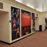 Theater hallway with promotional posters for "Welcome to McCarter" and orchestra seating information.