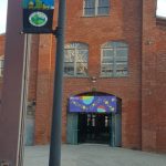 Brick building entrance with "Millyard Park" banner and "Trenton Circus Squad" sign.