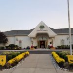 Entrance to Mercer Oaks community with a walkway leading to the main building.