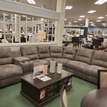 Large sectional sofa in a furniture showroom with bright interior lighting.
