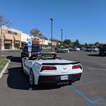 White Dodge Viper convertible parked in a sunny outdoor retail parking lot.