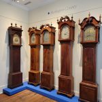 Antique grandfather clocks displayed in a museum exhibit at Burlington County.