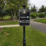 Signpost at Mountain View Golf Club directing to parking, golf shop, and bag drop.