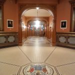 Grand, arched hallway with patterned floor and New Jersey state seal.