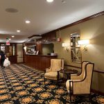 Elegant hotel lobby seating area with patterned carpet and warm lighting.
