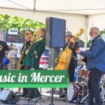 Live band performing outdoors in Mercer under a white tent.