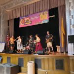 Musicians perform on a stage with an "Art All Night" banner visible behind them.