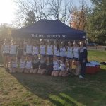 Students pose under a canopy for The Hill School XC event outdoors.