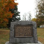 Memorial stone honoring General Hugh Mercer, set outdoors among autumn trees.